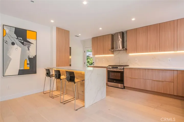 Spacious kitchen with island seating and open layout to living and dining areas.