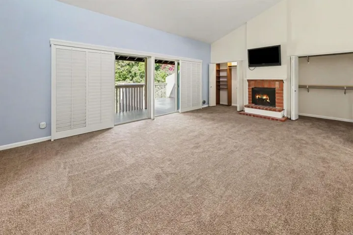 Huge primary bedroom w/ gas fireplace, new carpet, 3 closets, sliding door access to expansive deck