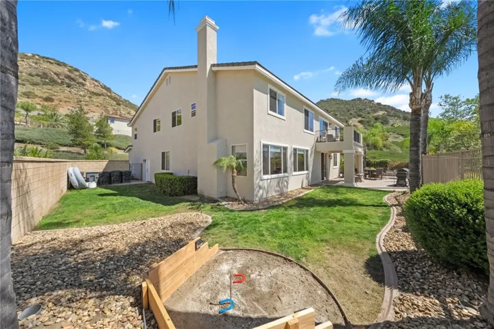 One side of the backyard-grassy area and horseshoe pit