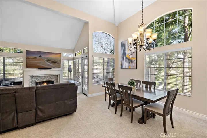Dining and living rooms enjoy plenty of natural light through large windows