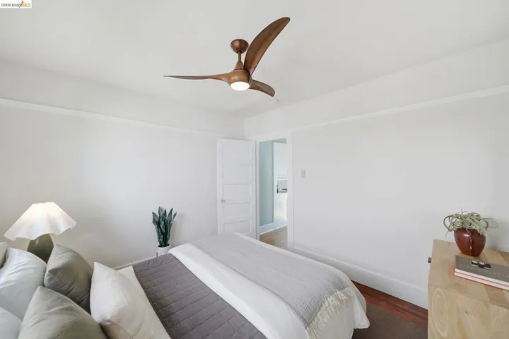 Bedroom with a ceiling fan and dark wood-style floors