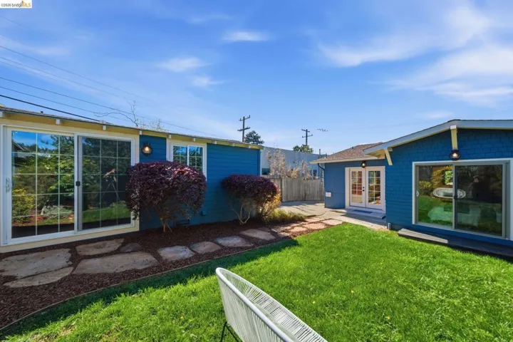 View of yard featuring a patio and french doors