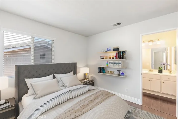 The inviting master bedroom leads to an ensuite bathroom equipped with a double sink vanity for a harmonious blend of comfort and convenience.