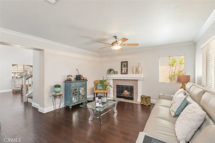 
A cozy room centered around a welcoming fireplace, casting a soft glow that enhances the room's inviting warmth.