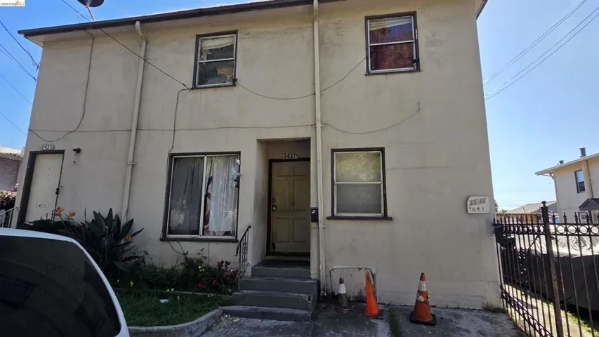 View of front of house featuring stucco siding and entry steps