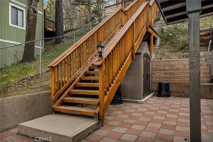 Bottom landing to entry to home with storage shed.