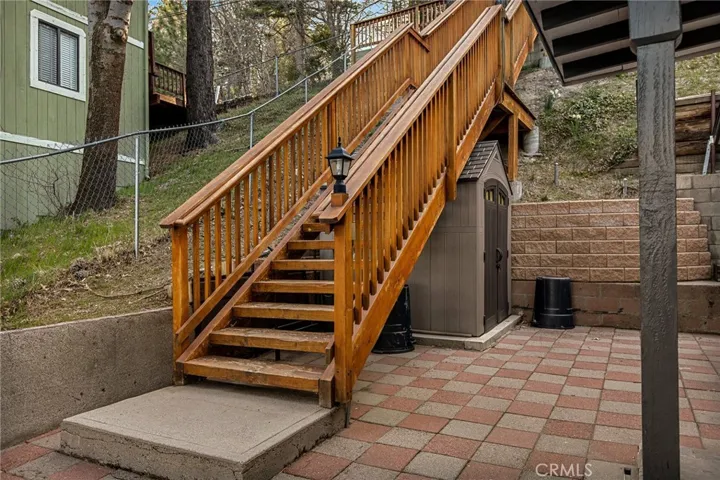 Bottom landing to entry to home with storage shed.