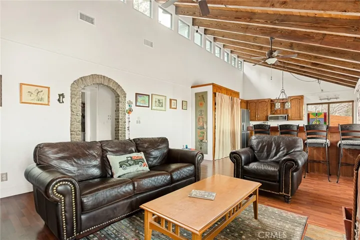 Single level cabin with living room open to kitchen with eat at bar.