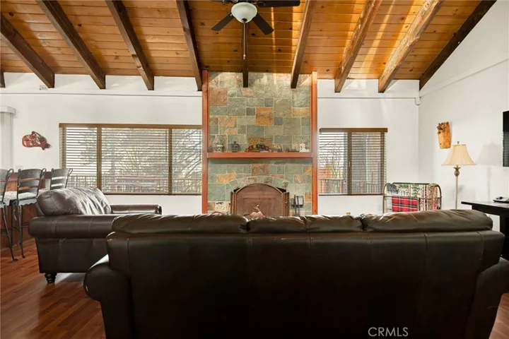 Living room with beautiful stone fireplace.