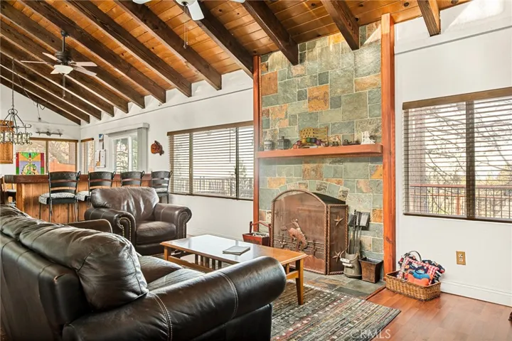 Living room with vaulted knotty pine ceilings.