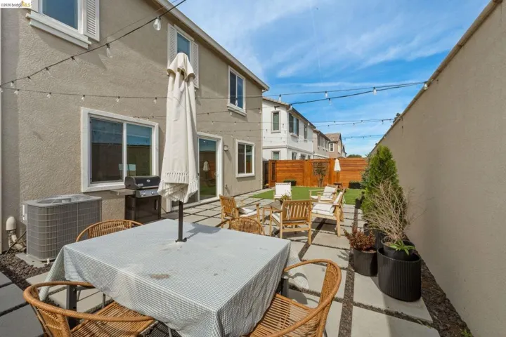 Fenced backyard featuring outdoor dining space, a patio, and area for grilling