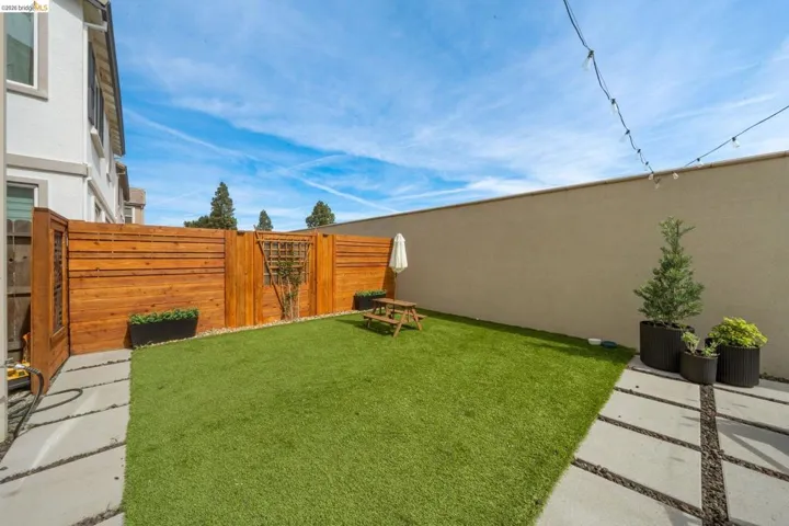 Fenced backyard featuring a gate