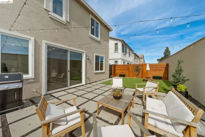 Fenced backyard featuring outdoor furniture, area for grilling, and a patio area