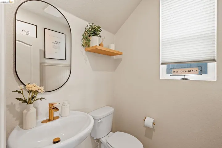 Bathroom featuring toilet and lofted ceiling