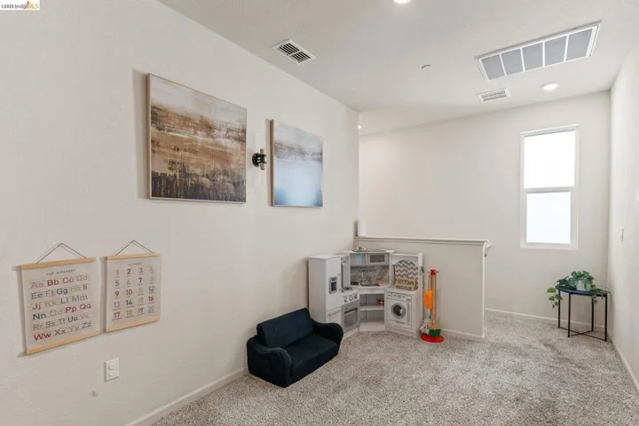 Game room featuring light carpet and baseboards