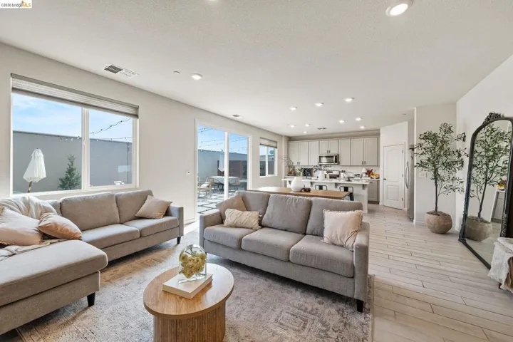 Living area featuring light wood-style floors, recessed lighting, and plenty of natural light