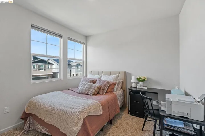 Bedroom featuring carpet and an office area