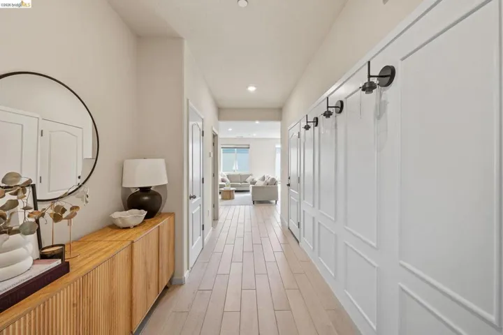Hall with light wood-style flooring and recessed lighting