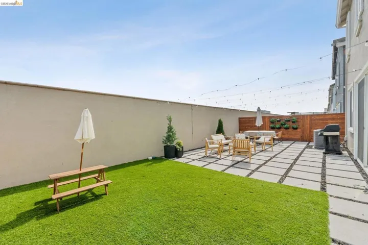 Fenced backyard featuring a patio and an outdoor living space