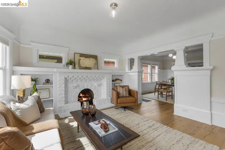 Living area with hardwood / wood-style floors, a fireplace, and built in shelves