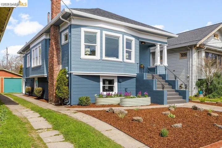 View of front facade with a chimney and a garage