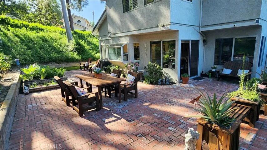 Rear yard with enormous brick patio areas