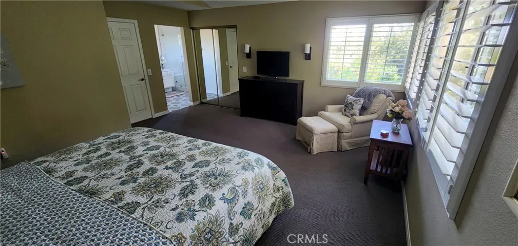 Primary bedroom with mirrored door to walk-in closet