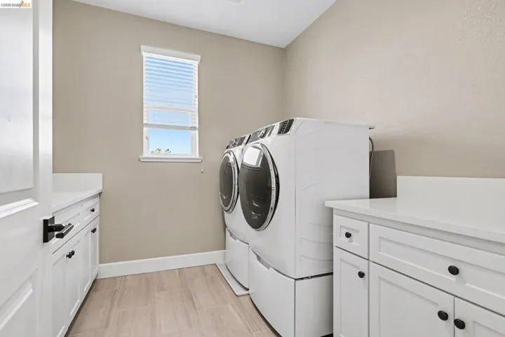 Laundry room featuring cabinet space and washer and dryer
