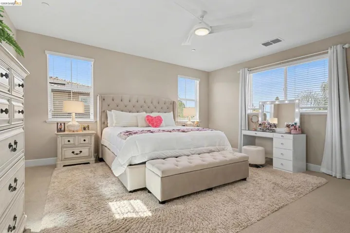 Bedroom featuring light carpet and a ceiling fan