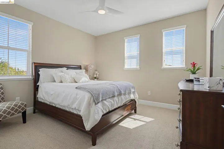 Bedroom featuring light colored carpet and a ceiling fan