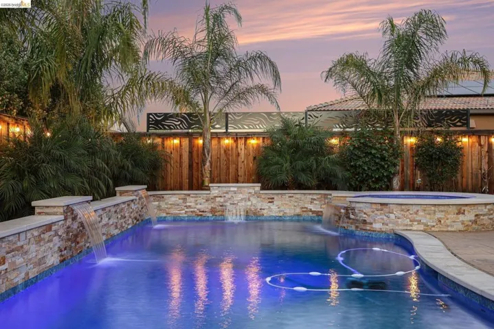 Combined pool / hot tub with a patio