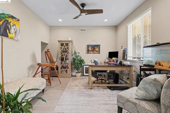 Office space with a ceiling fan, light wood-type flooring, and recessed lighting