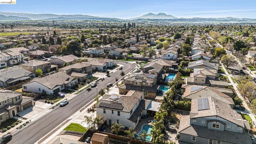 Aerial perspective of suburban area featuring a mountain backdrop
