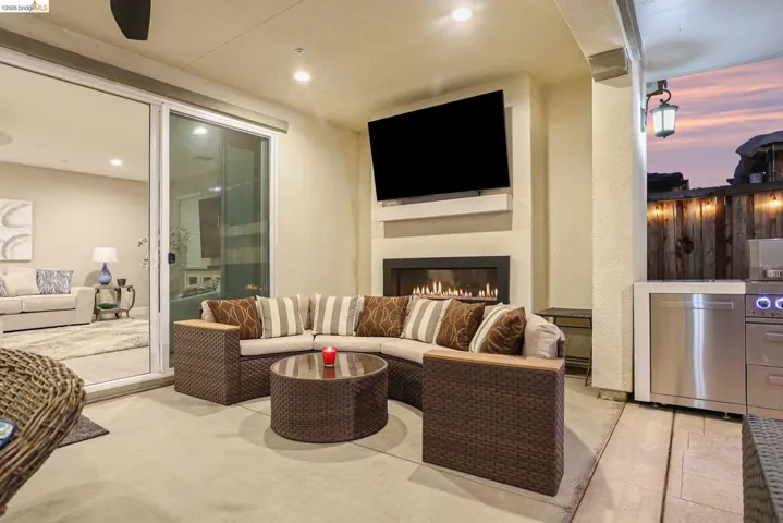 View of patio featuring an outdoor living space with a fireplace