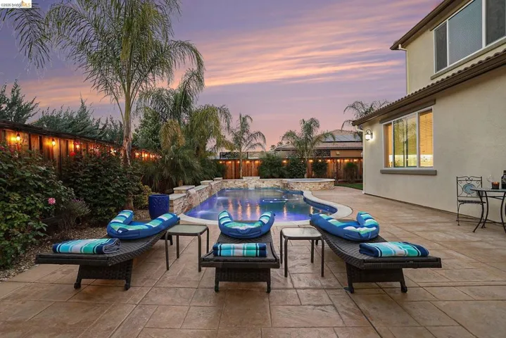 Relaxing pool / spa featuring a patio area and a fenced backyard