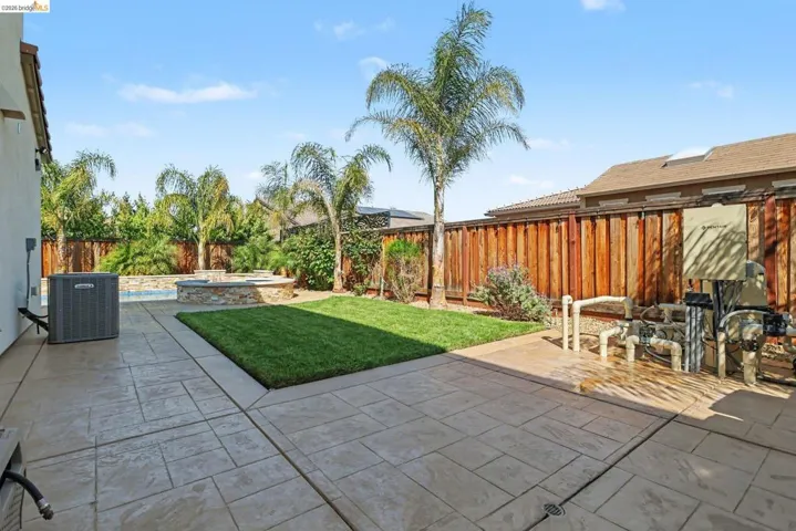 Fenced backyard with a patio
