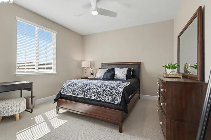 Bedroom with light carpet and ceiling fan