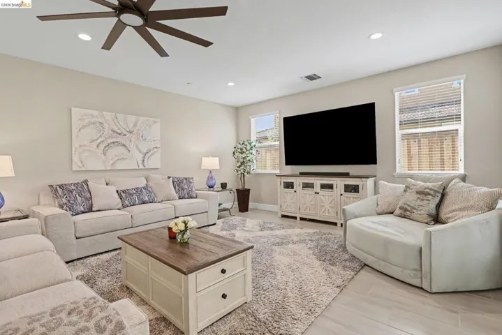 Living room featuring ceiling fan, light wood-style floors, and recessed lighting