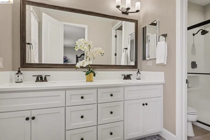 Bathroom with double vanity and a stall shower
