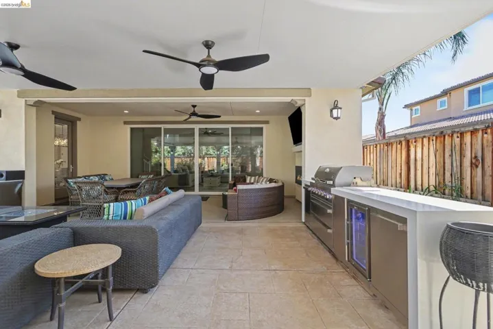 View of patio / terrace featuring area for grilling, a ceiling fan, and an outdoor living / dining area