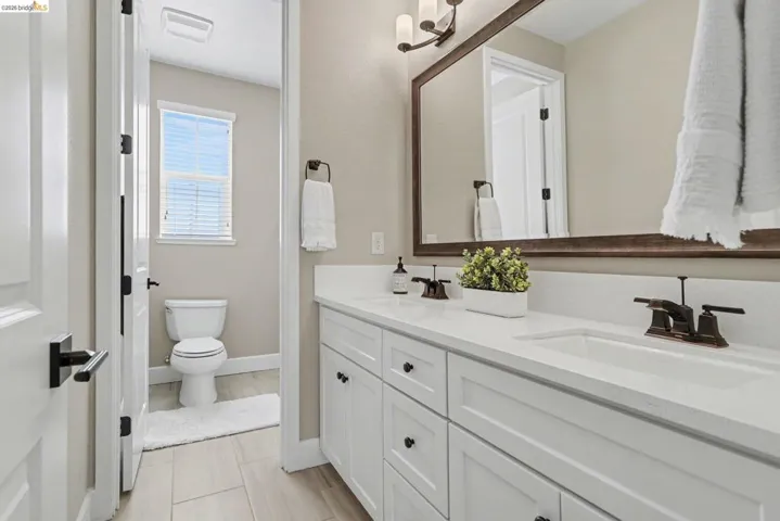 Full bath with double vanity and toilet