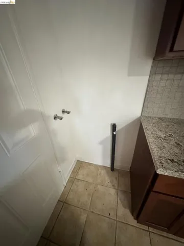 Bathroom featuring light tile patterned flooring and baseboards