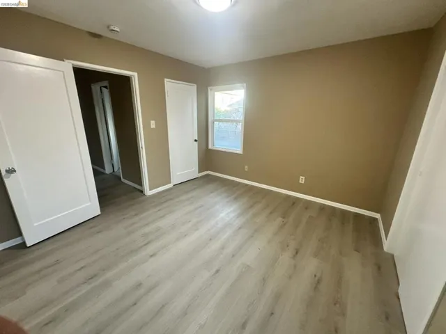 Unfurnished bedroom featuring baseboards and light wood-type flooring