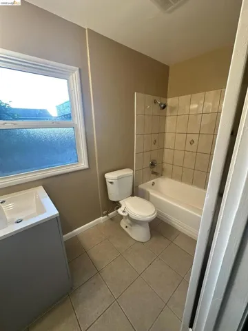 Full bathroom featuring vanity, light tile patterned flooring, and shower / bathtub combination