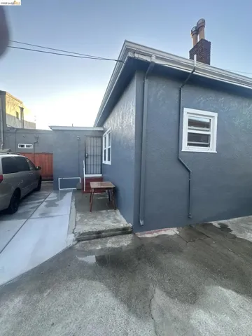 View of property exterior with stucco siding and a chimney
