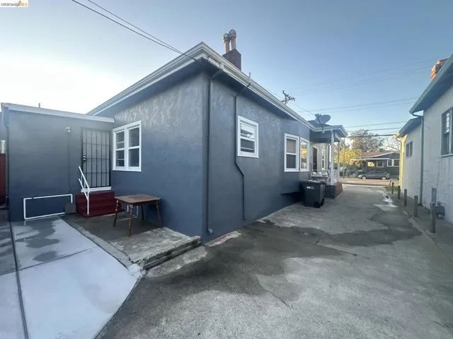 View of side of home with a chimney and stucco siding