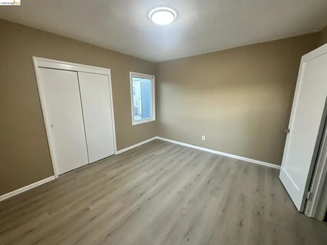 Unfurnished bedroom with a closet and light wood-style floors