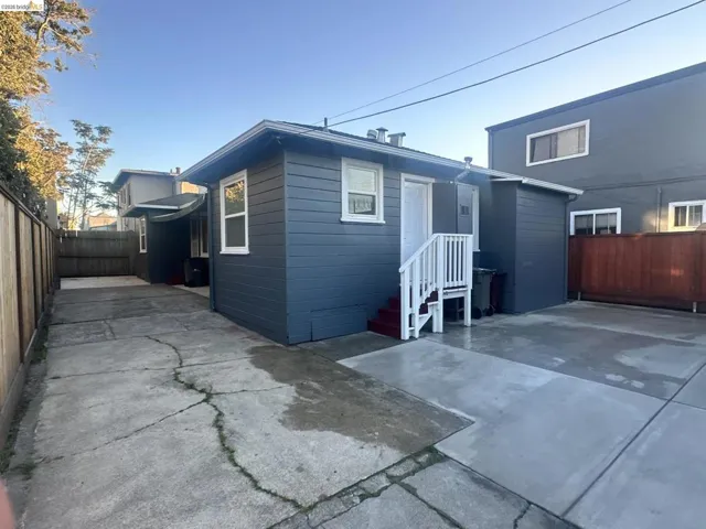 Rear view of house with a fenced backyard
