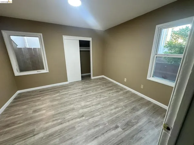 Unfurnished bedroom with light wood finished floors and a closet