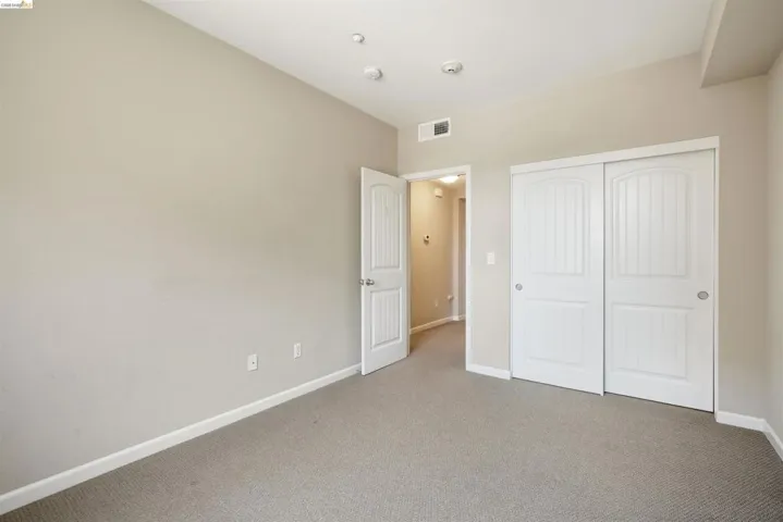 Unfurnished bedroom featuring carpet and a closet